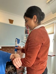 Chiropractor Kanika treating an elbow with the shockwave machine